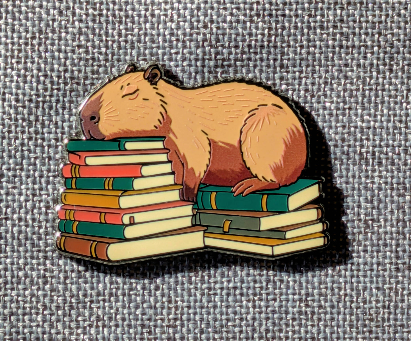 Capybara Sleeping on Books Enamel Pin - 1.5"
