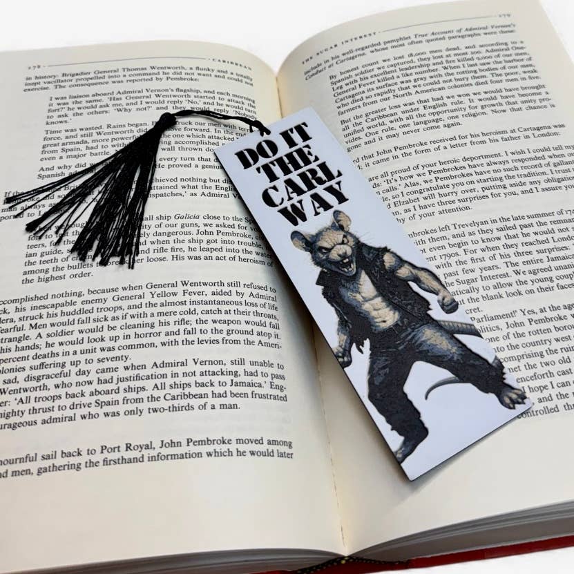 Bookmark with bear illustration and text on an open book