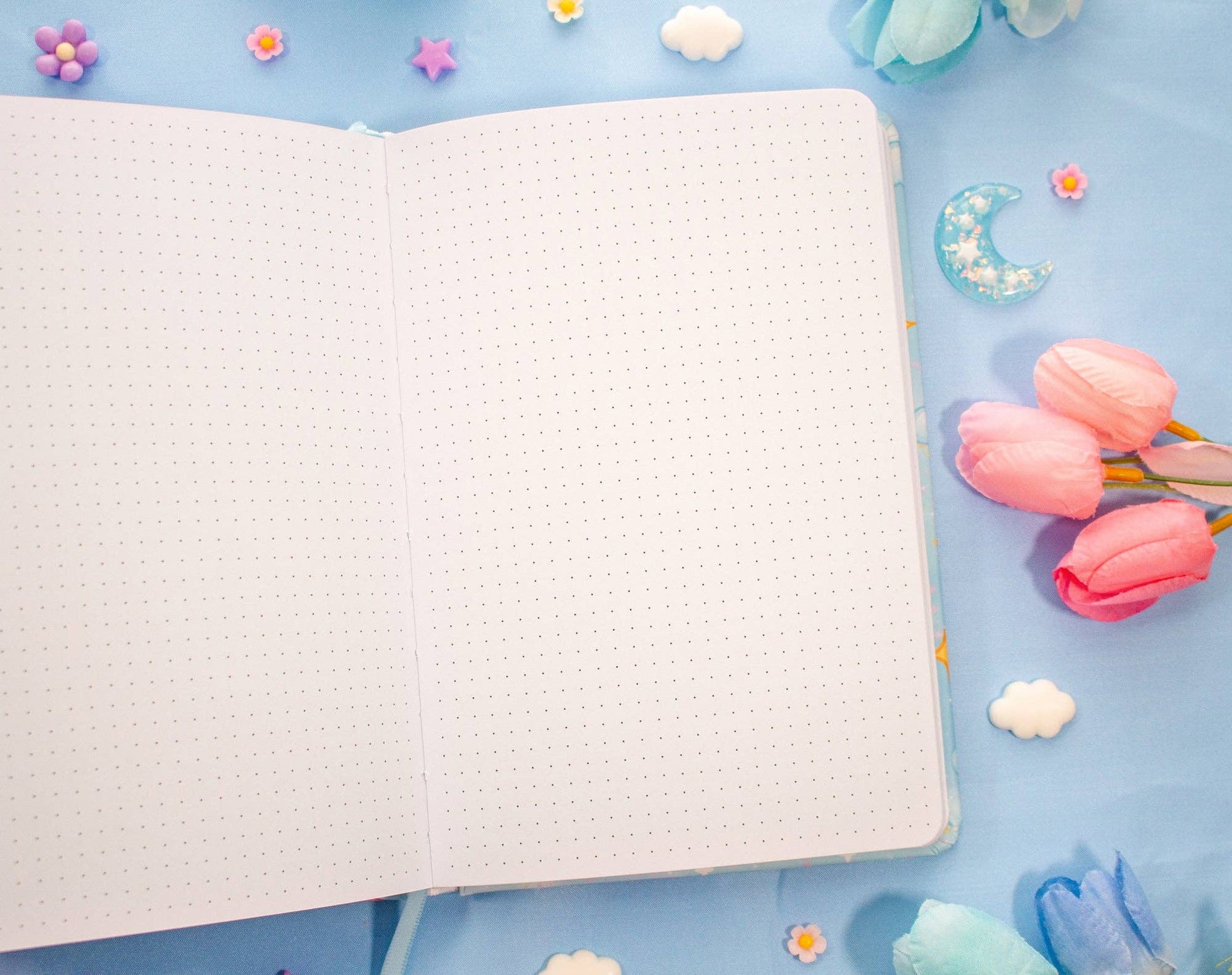 Notebook on a blue background with decorative elements