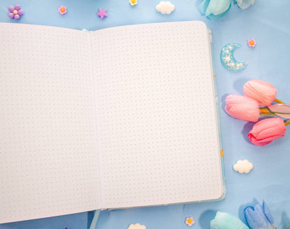 Notebook on a blue background with decorative elements