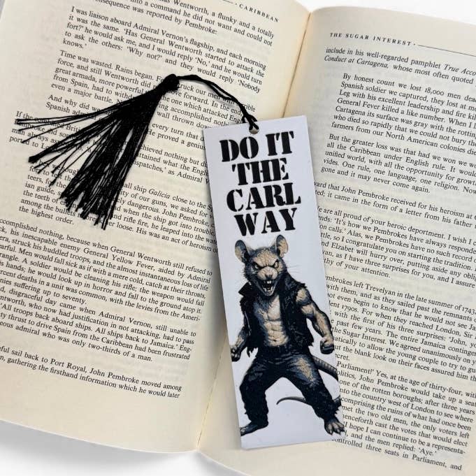 Bookmark with a bear graphic and text on an open book