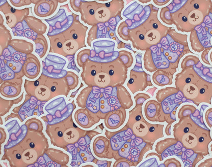 Pattern of teddy bears with hats and bows in purple and pink tones.
