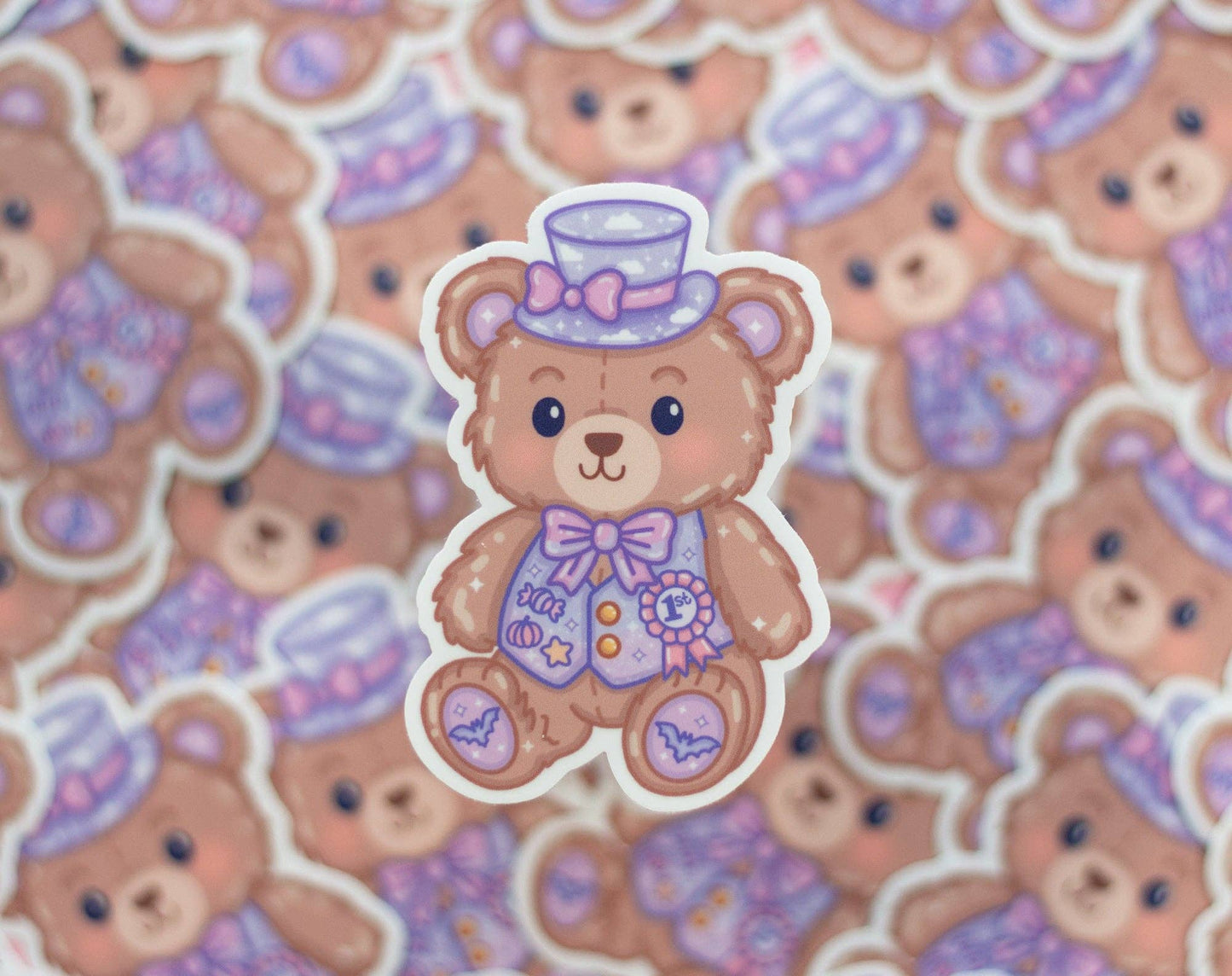 Sticker of a teddy bear with a top hat and bow tie on a patterned background